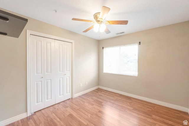 861 W Columbia Ln Unit 21, Provo, UT 84604 - unfurnished bedroom with light wood-style flooring, a closet, and a ceiling fan