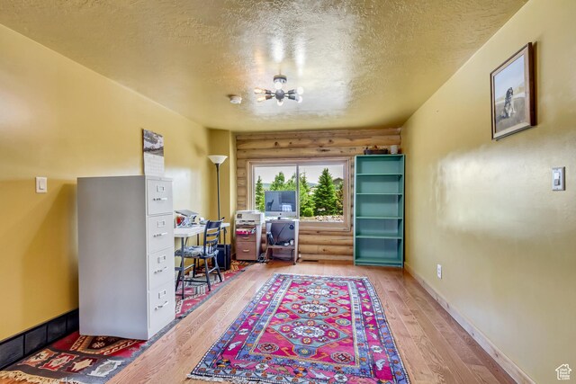 366 E Valley Dr S, Park City, UT 84098 - office featuring a textured ceiling, light wood-style floors, a chandelier, and rustic walls