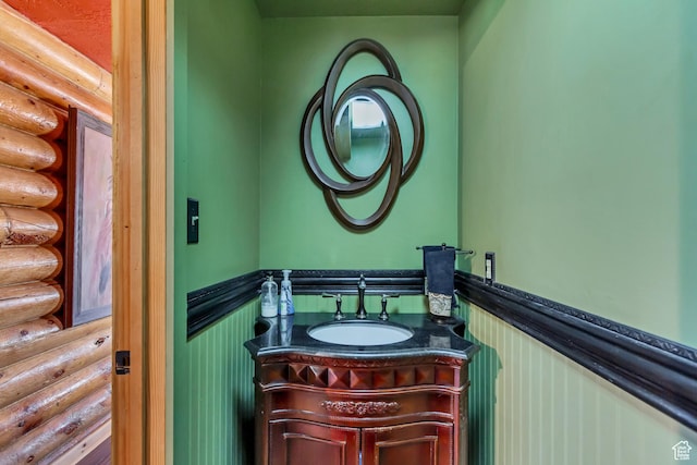 366 E Valley Dr S, Park City, UT 84098 - bathroom featuring rustic walls, a wainscoted wall, and vanity