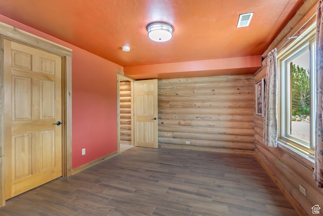 366 E Valley Dr S, Park City, UT 84098 - empty room featuring log walls, dark wood-type flooring, and a smoke detector