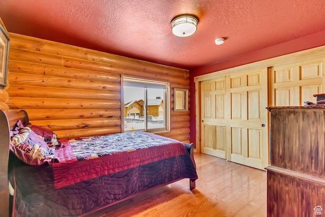 366 E Valley Dr S, Park City, UT 84098 - bedroom featuring rustic walls, a textured ceiling, and wood finished floors