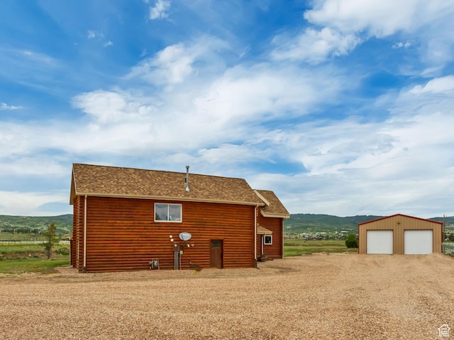 366 E Valley Dr S, Park City, UT 84098 - view of home's exterior with dirt driveway, a garage, an outdoor structure, and a mountain view