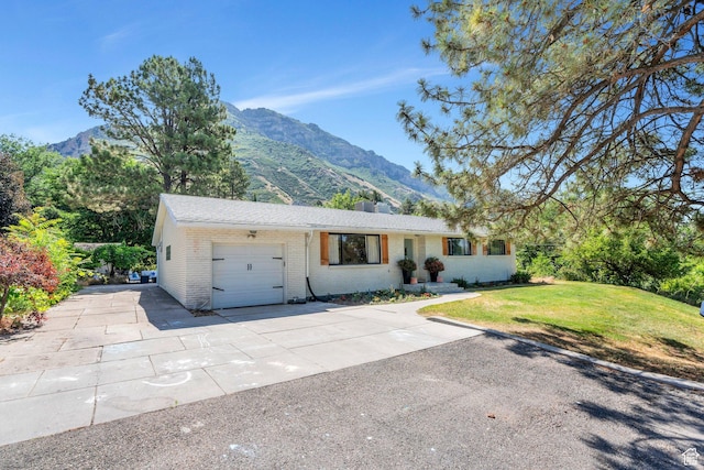 2040 N Oakcrest Ter, Provo, UT 84604 - ranch-style home with a mountain view, brick siding, an attached garage, and concrete driveway