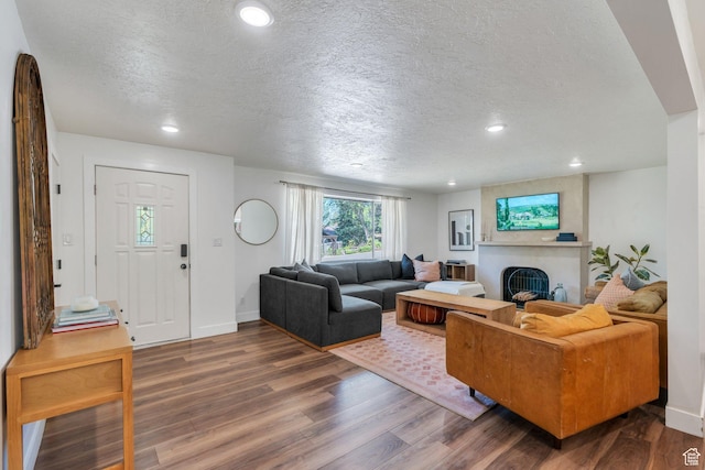 2040 N Oakcrest Ter, Provo, UT 84604 - living room featuring a textured ceiling, dark wood-type flooring, recessed lighting, and a fireplace