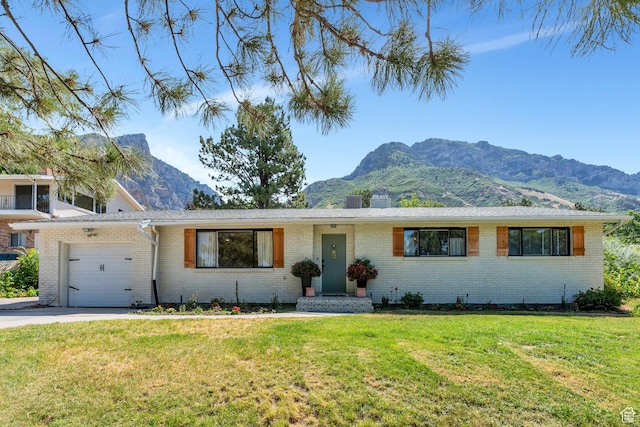 2040 N Oakcrest Ter, Provo, UT 84604 - ranch-style home with a mountain view, an attached garage, and brick siding