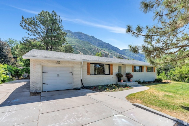 2040 N Oakcrest Ter, Provo, UT 84604 - ranch-style home featuring a mountain view, a garage, brick siding, and concrete driveway