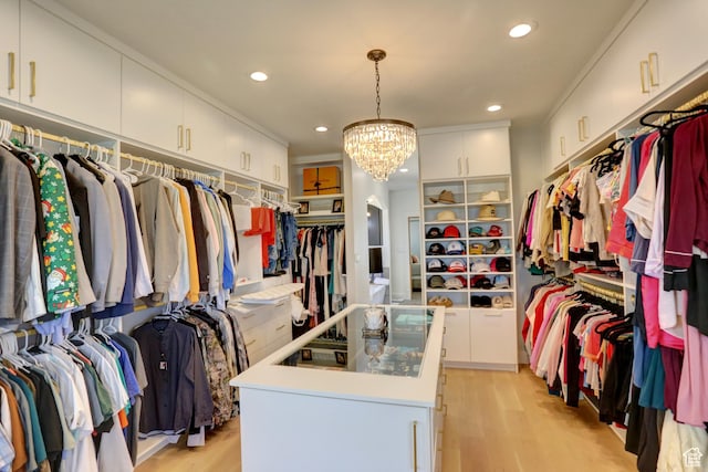 1767 S 800 W, Mapleton, UT 84664 - walk in closet with light wood-style flooring, arched walkways, and a chandelier