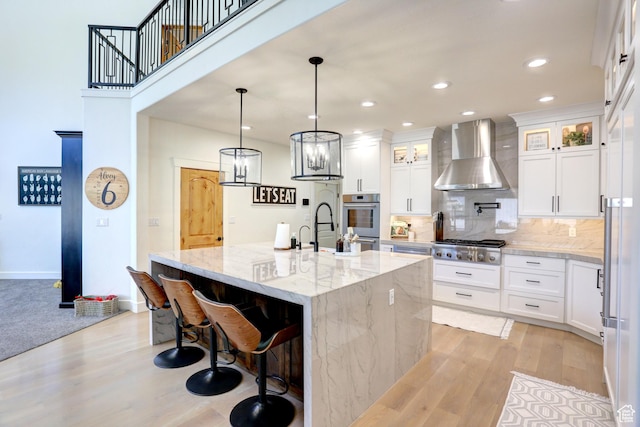 1767 S 800 W, Mapleton, UT 84664 - kitchen featuring wall chimney range hood, light wood-style flooring, stainless steel appliances, backsplash, and recessed lighting