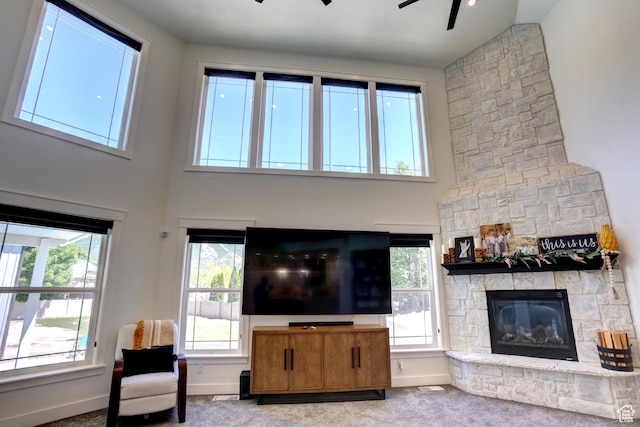 1767 S 800 W, Mapleton, UT 84664 - carpeted living room featuring a ceiling fan, a high ceiling, and a fireplace