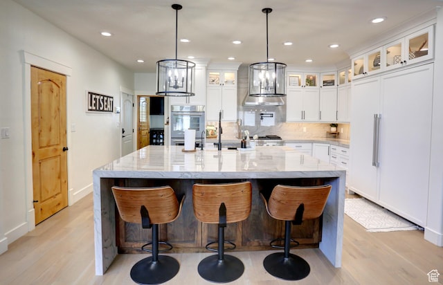 1767 S 800 W, Mapleton, UT 84664 - kitchen featuring paneled refrigerator, light wood-type flooring, decorative backsplash, a large island, and recessed lighting