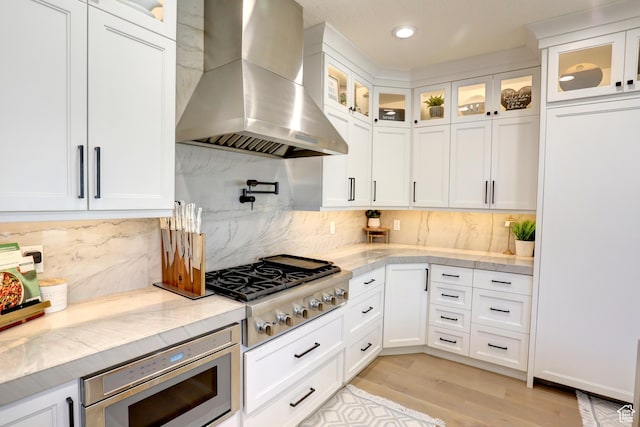 1767 S 800 W, Mapleton, UT 84664 - kitchen featuring wall chimney range hood, stainless steel appliances, white cabinetry, light wood-style flooring, and recessed lighting
