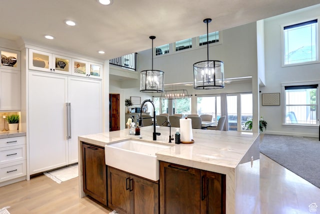 1767 S 800 W, Mapleton, UT 84664 - kitchen featuring recessed lighting, open floor plan, light stone countertops, white cabinets, and paneled fridge