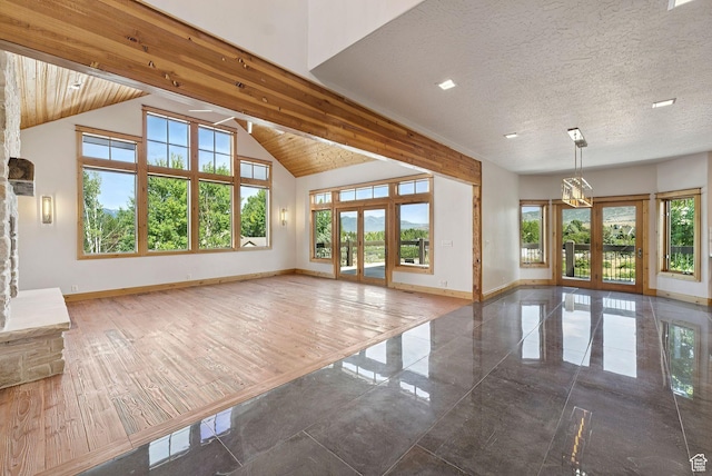 4555 Palomino Dr, Heber City, UT 84032 - unfurnished living room with healthy amount of natural light, french doors, and high vaulted ceiling