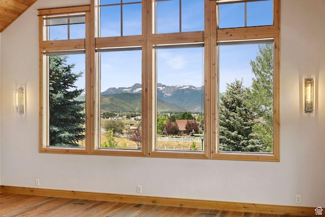 4555 Palomino Dr, Heber City, UT 84032 - empty room featuring a mountain view, wood finished floors, and vaulted ceiling