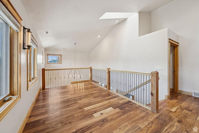 4555 Palomino Dr, Heber City, UT 84032 - hall featuring lofted ceiling, wood finished floors, a skylight, recessed lighting, and an upstairs landing