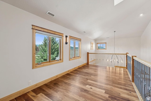 4555 Palomino Dr, Heber City, UT 84032 - empty room featuring wood finished floors, vaulted ceiling, and recessed lighting