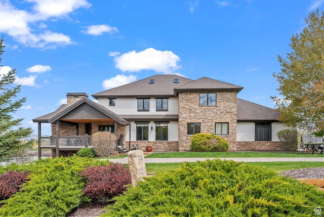 4555 Palomino Dr, Heber City, UT 84032 - view of front of property with stone siding, stucco siding, a chimney, and a shingled roof