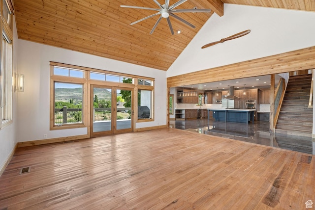 4555 Palomino Dr, Heber City, UT 84032 - unfurnished living room with high vaulted ceiling, ceiling fan, wood finished floors, healthy amount of natural light, and stairway