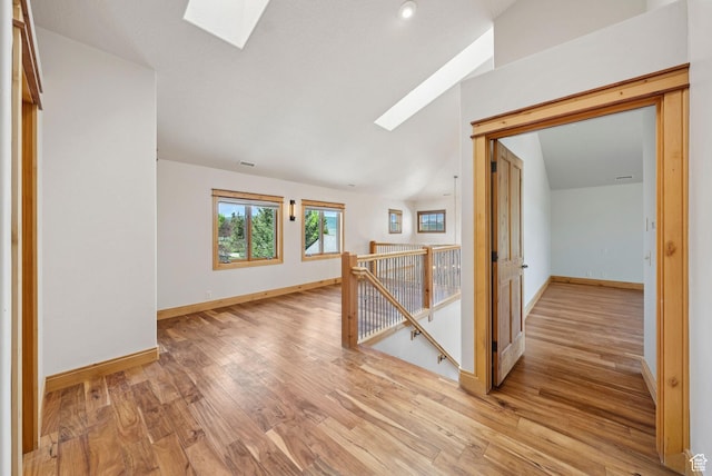 4555 Palomino Dr, Heber City, UT 84032 - empty room featuring a skylight, light wood-style floors, and lofted ceiling