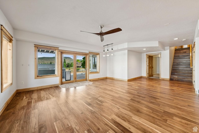 4555 Palomino Dr, Heber City, UT 84032 - unfurnished living room featuring ceiling fan, stairway, light wood finished floors, and recessed lighting