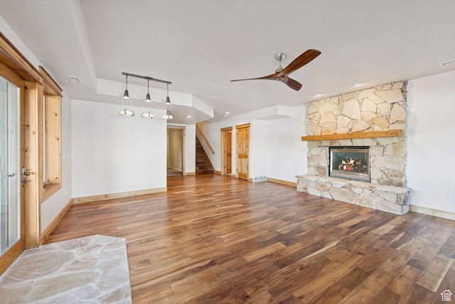 4555 Palomino Dr, Heber City, UT 84032 - unfurnished living room with stairs, wood finished floors, a stone fireplace, and a ceiling fan