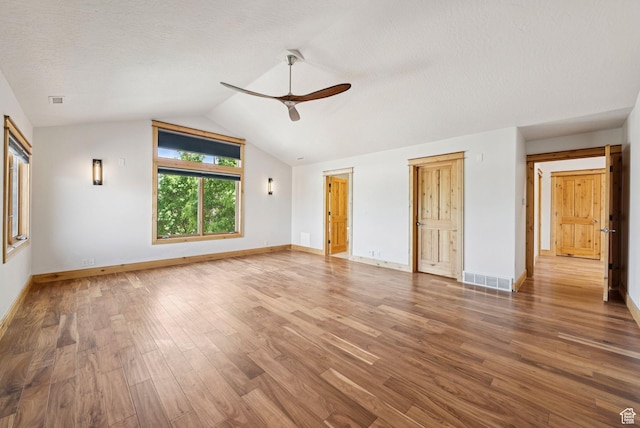4555 Palomino Dr, Heber City, UT 84032 - unfurnished living room featuring a ceiling fan, wood finished floors, vaulted ceiling, and a textured ceiling