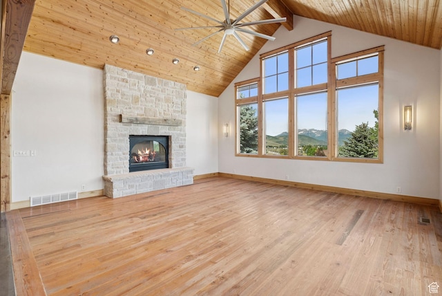4555 Palomino Dr, Heber City, UT 84032 - unfurnished living room featuring high vaulted ceiling, ceiling fan, a stone fireplace, a wood ceiling with exposed beams, and wood finished floors