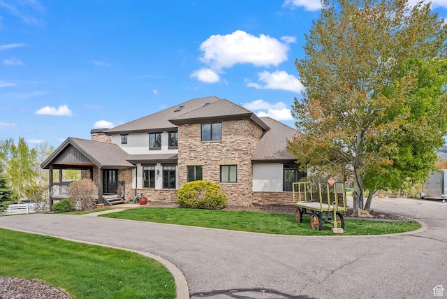 4555 Palomino Dr, Heber City, UT 84032 - view of front of house with stone siding, a front lawn, roof with shingles, and stucco siding