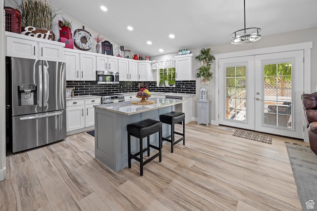 1343 W 870 N, Pleasant Grove, UT 84062 - kitchen with stainless steel appliances, french doors, white cabinets, tasteful backsplash, and a kitchen breakfast bar