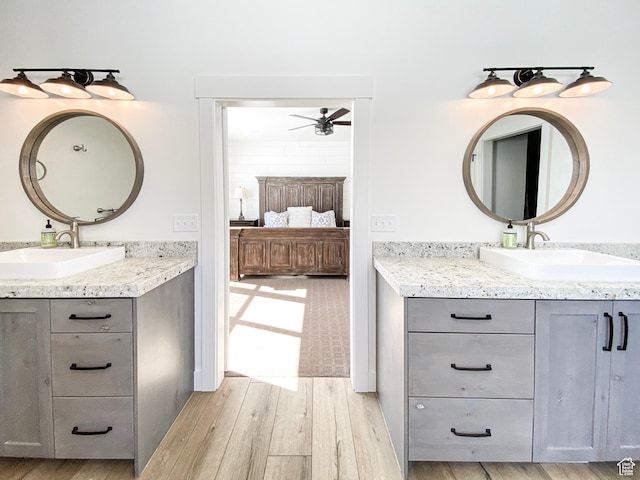 96 W 350 S, Garden City, UT 84028 - bathroom featuring ensuite bath, a ceiling fan, wood finished floors, and two vanities