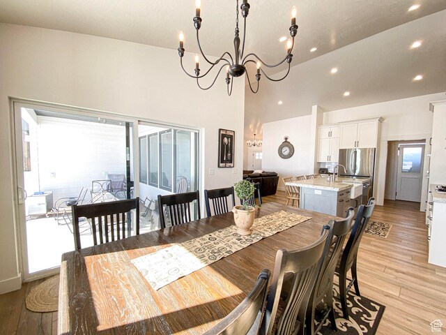 96 W 350 S, Garden City, UT 84028 - dining space featuring a chandelier, recessed lighting, light wood finished floors, and a towering ceiling
