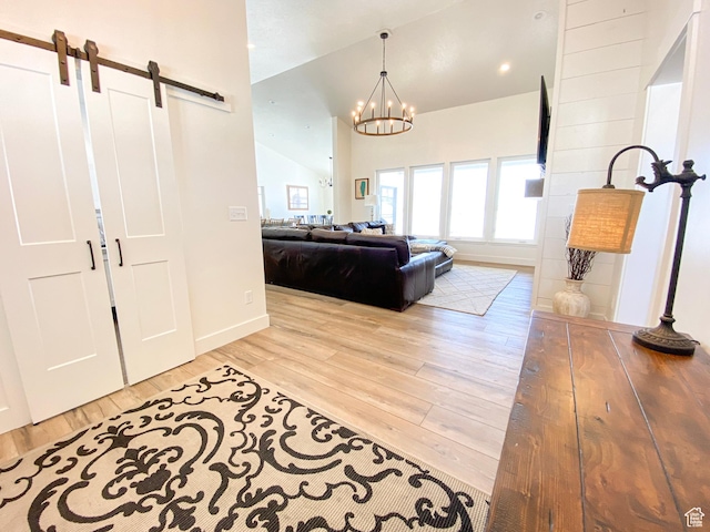 96 W 350 S, Garden City, UT 84028 - foyer entrance with a barn door, wood finished floors, vaulted ceiling, and a chandelier