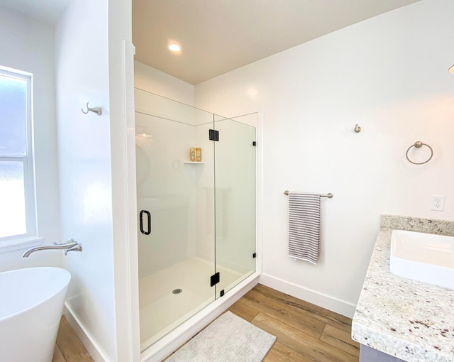 96 W 350 S, Garden City, UT 84028 - bathroom featuring a shower stall, vanity, a freestanding bath, wood finished floors, and healthy amount of natural light