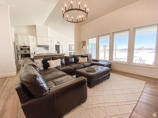 96 W 350 S, Garden City, UT 84028 - living area with a chandelier, light wood-style floors, plenty of natural light, and high vaulted ceiling