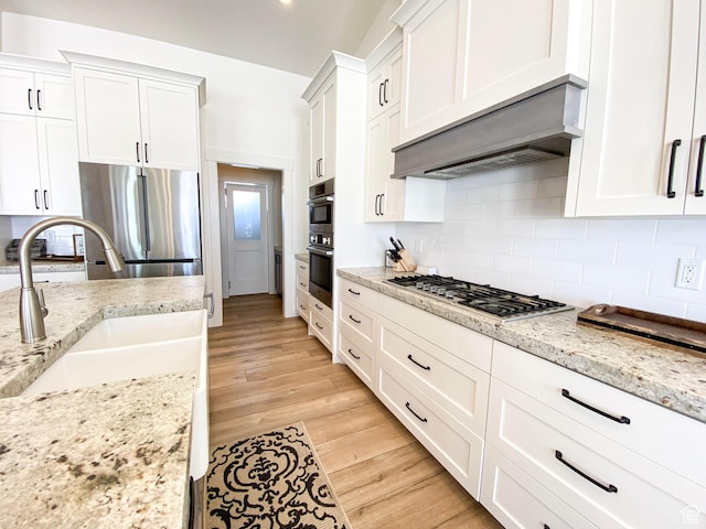 96 W 350 S, Garden City, UT 84028 - kitchen featuring stainless steel appliances, white cabinets, backsplash, and light wood-style flooring