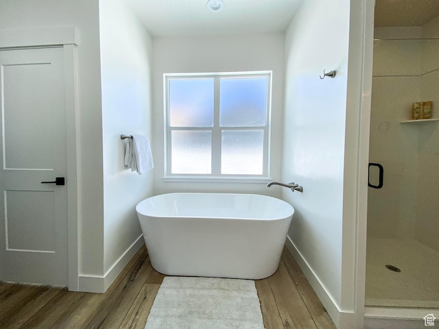 96 W 350 S, Garden City, UT 84028 - bathroom featuring wood finished floors, a freestanding tub, and a stall shower