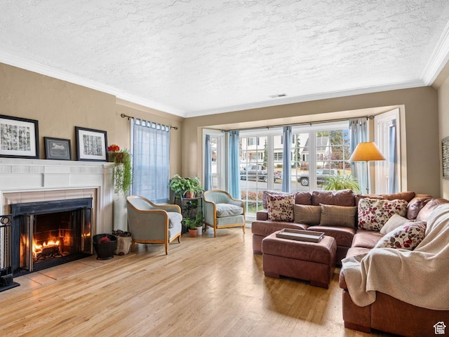 1728 E 27th St, Ogden, UT 84403 - living area featuring wood finished floors, a textured ceiling, a fireplace with flush hearth, and ornamental molding