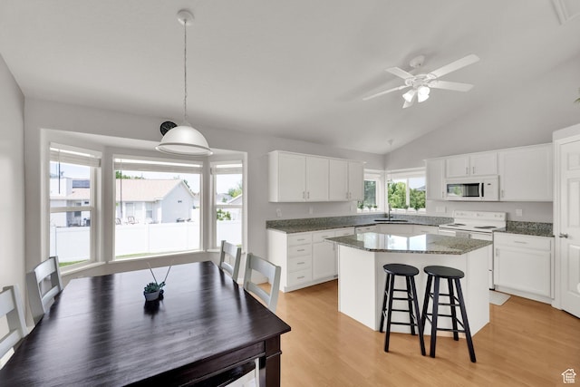 6470 S Wakefield Way, Salt Lake City, UT 84118 - kitchen featuring white appliances, a kitchen breakfast bar, a kitchen island, white cabinets, and ceiling fan