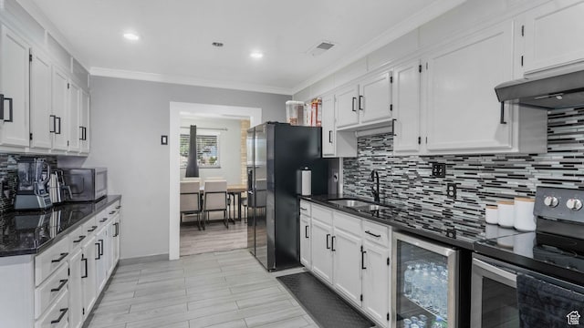 5356 S 4280 W, Salt Lake City, UT 84118 - kitchen with stainless steel appliances, beverage cooler, decorative backsplash, crown molding, and recessed lighting