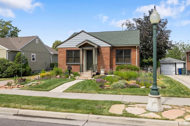 2664 S Melbourne St E, Salt Lake City, UT 84106 - view of front of home with brick siding, an outbuilding, a front yard, a detached garage, and roof with shingles
