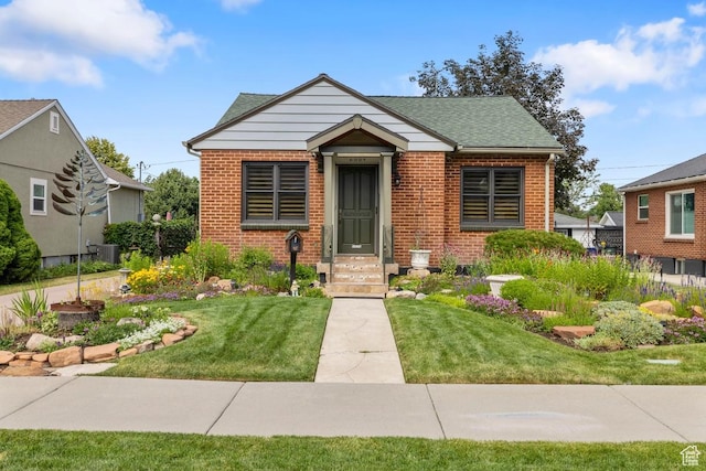 2664 S Melbourne St E, Salt Lake City, UT 84106 - bungalow-style home with brick siding, a front yard, and a shingled roof