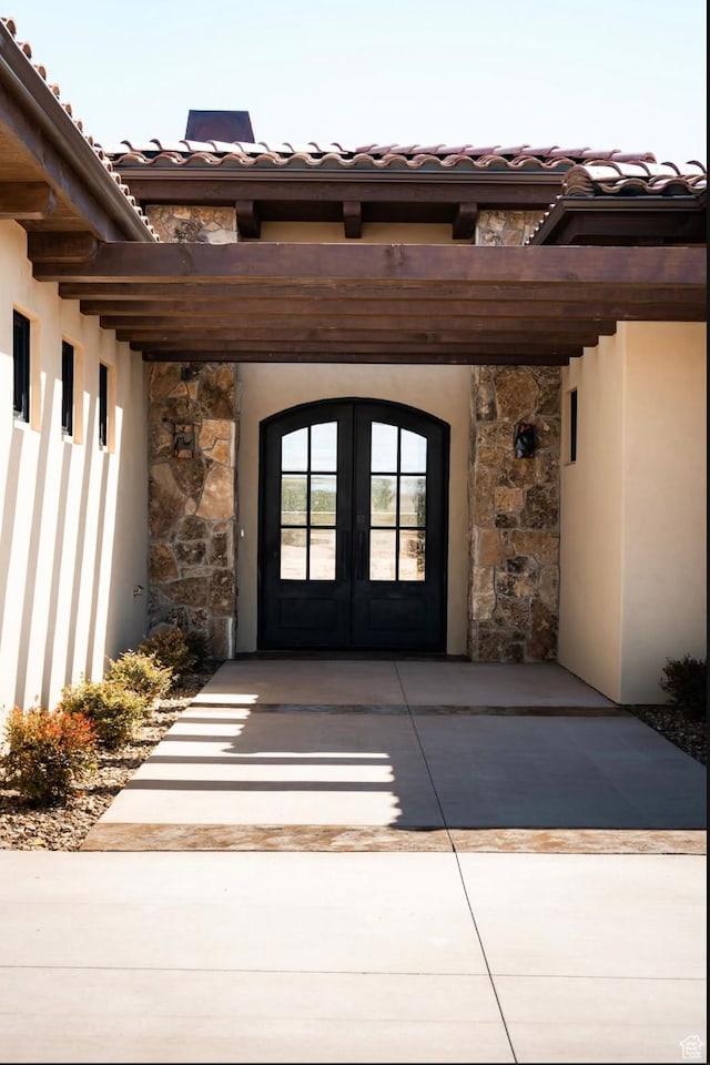 442 E Entrada Dr, Virgin, UT 84779 - view of exterior entry with french doors, stone siding, a tile roof, and stucco siding