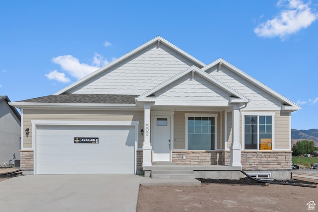 131 N 950 E Unit 35, Tremonton, UT 84337 - craftsman inspired home featuring stone siding, driveway, a porch, and an attached garage