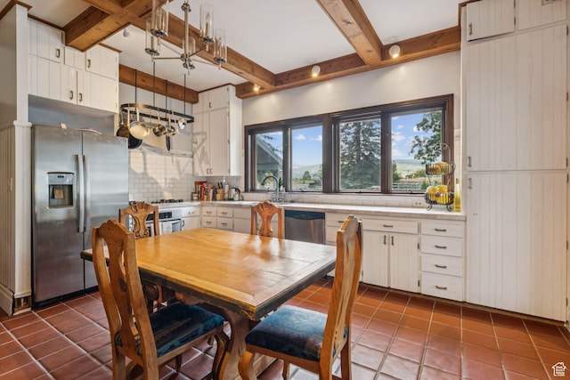 455 E Boulderville Rd, Oakley, UT 84055 - dining area with beamed ceiling and tile patterned flooring