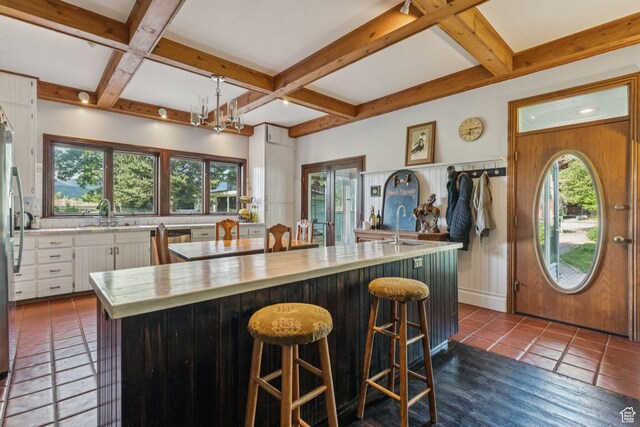 455 E Boulderville Rd, Oakley, UT 84055 - kitchen with coffered ceiling, light countertops, beamed ceiling, a center island, and white cabinetry