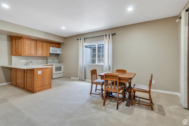 1125 E 740 S, Pleasant Grove, UT 84062 - kitchen with white appliances, light carpet, a peninsula, recessed lighting, and light countertops
