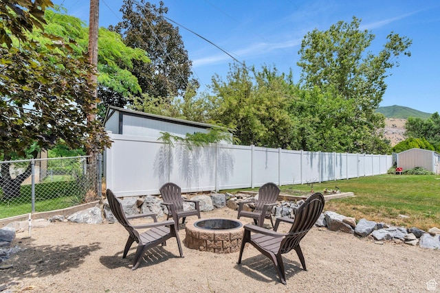 1125 E 740 S, Pleasant Grove, UT 84062 - fenced backyard featuring a fire pit, a shed, and a mountain view