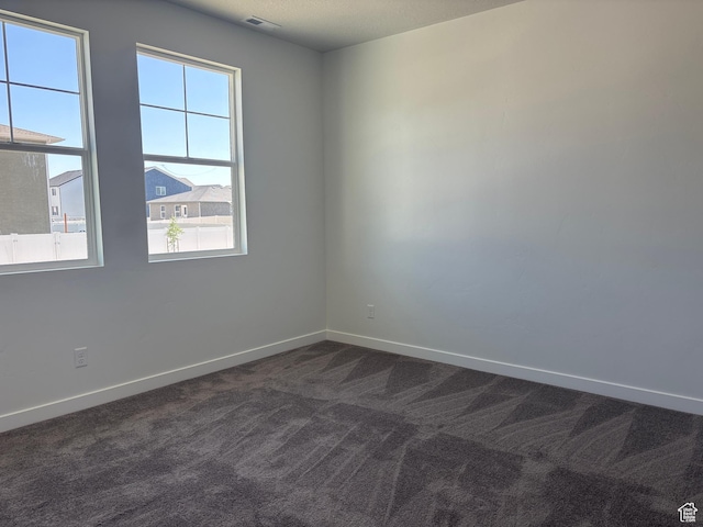 1574 E Pheasant Rd Unit 211, Eagle Mountain, UT 84005 - spare room featuring dark carpet and baseboards