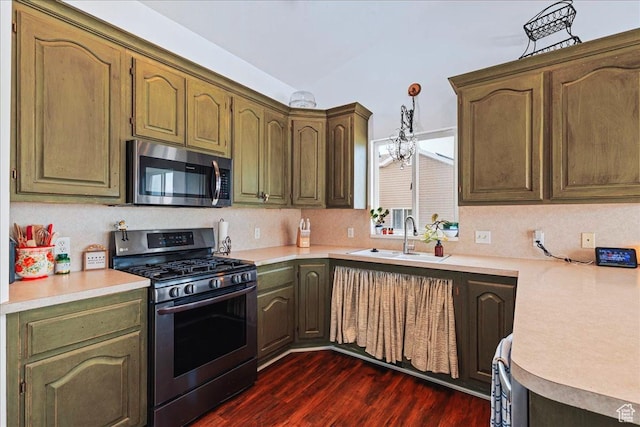 14133 S Lowe Peak Cir, Riverton, UT 84096 - kitchen with stainless steel appliances, light countertops, dark wood-style flooring, and hanging light fixtures