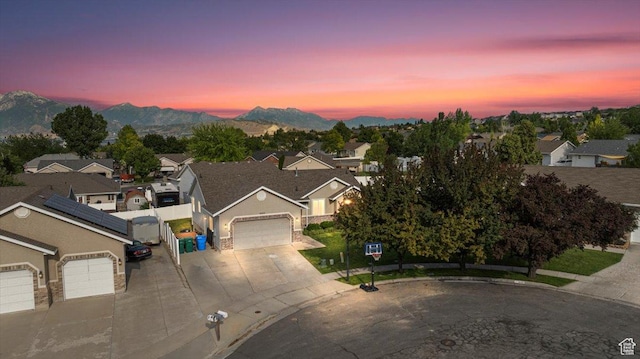 14133 S Lowe Peak Cir, Riverton, UT 84096 - view of front of house featuring a garage, concrete driveway, a mountain view, and a residential view